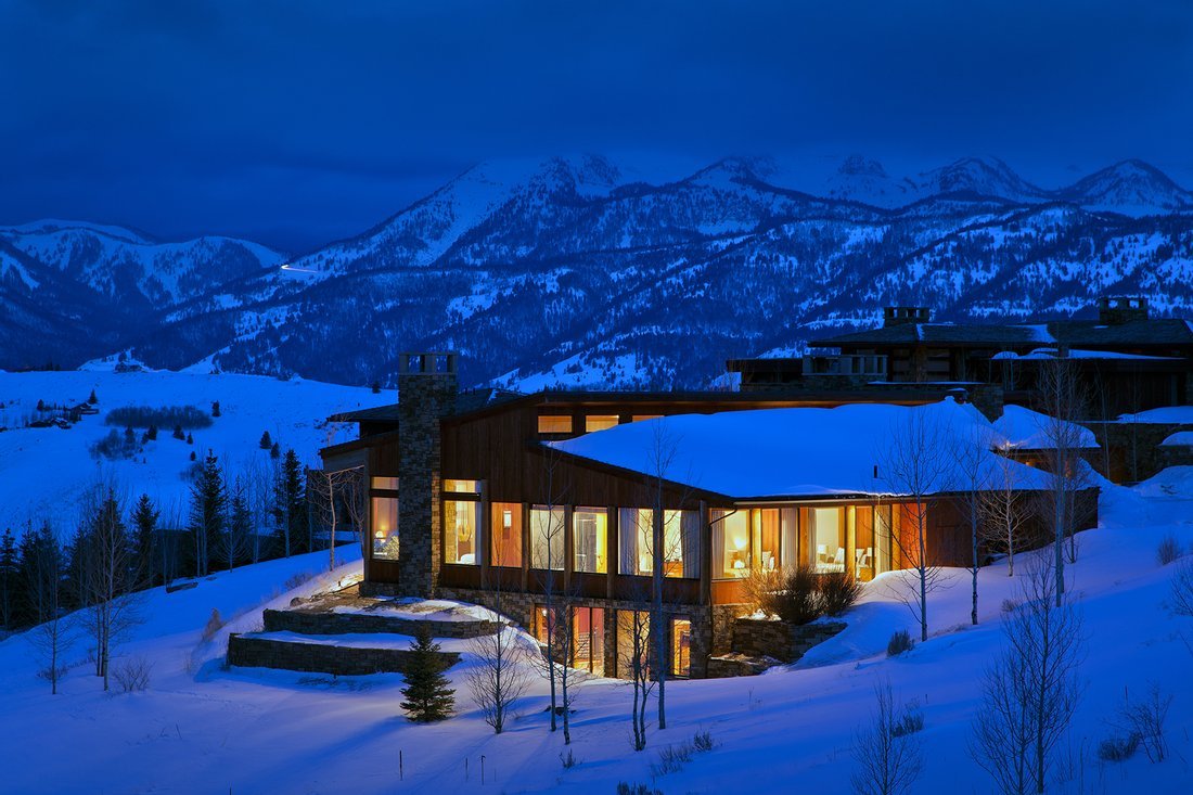 Luxury mountain homes with wooden balconies in Colorado mountains and North Carolina mountains.